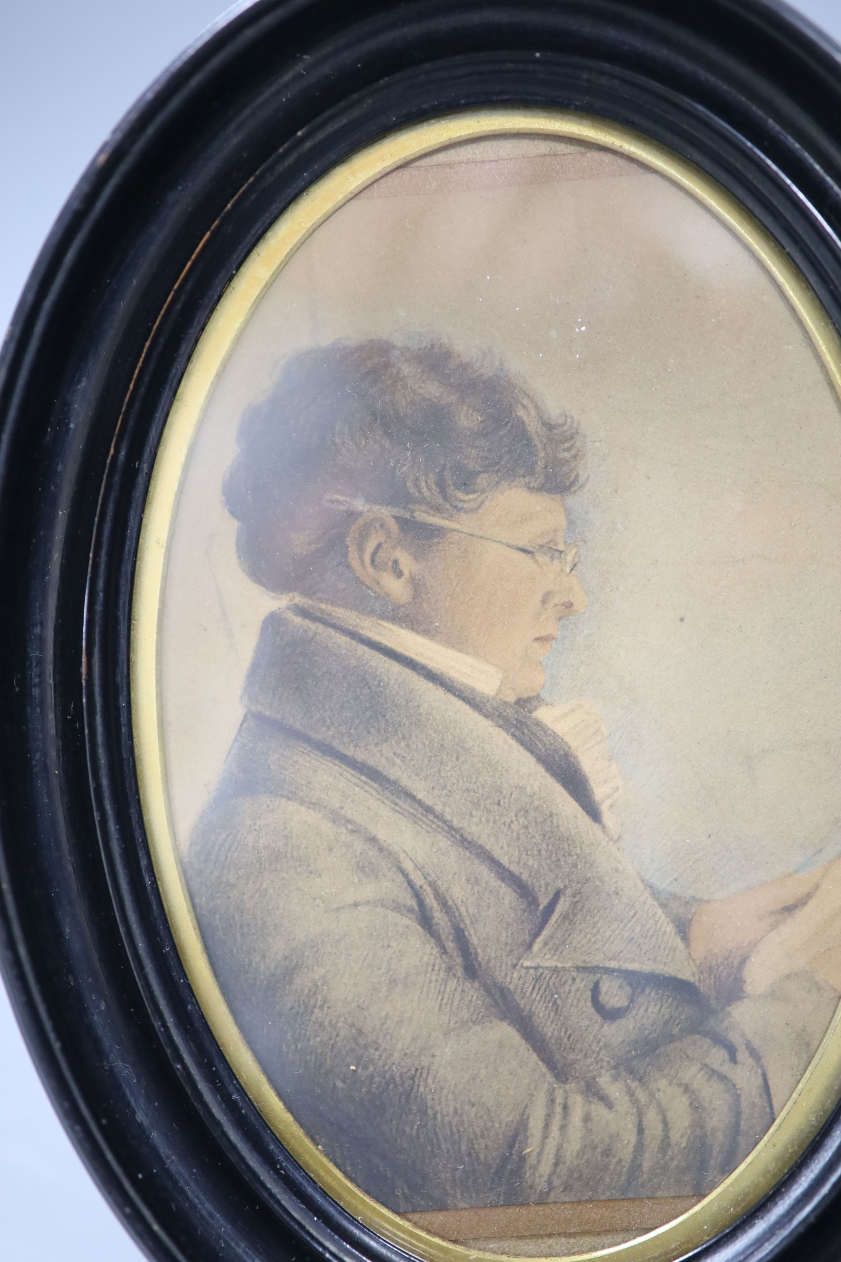 A miniature portrait of a gentleman reading, in a Walter Jones of Sloane Street frame, 1890's, height 15cm